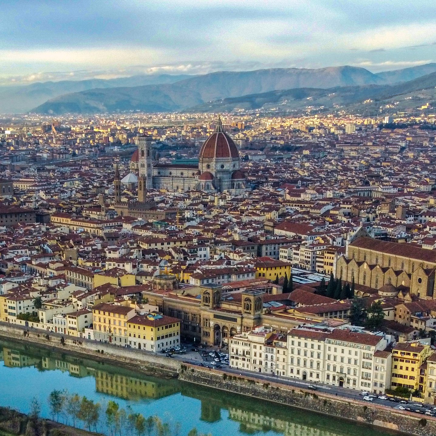 View of Florence with the Florence Cathedral and its iconic dome, surrounded by historic buildings.